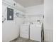Laundry room with washer, dryer, and ample shelving at 2806 Salamanca St, The Villages, FL 32162