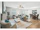 Spacious living room with hardwood floors, a ceiling fan, and ample natural light at 2806 Salamanca St, The Villages, FL 32162
