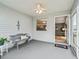 Bright screened porch with a bench and view of the living room at 2806 Salamanca St, The Villages, FL 32162