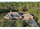 Aerial view of house, two-car garage, wooded lot at 30629 Alder Ave, Eustis, FL 32736