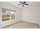 Bright bedroom with ceiling fan and large window at 30629 Alder Ave, Eustis, FL 32736