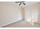 Well-lit bedroom featuring a ceiling fan and double door closet at 30629 Alder Ave, Eustis, FL 32736