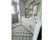 Modern bathroom with double vanity, patterned floor, and shower at 3180 Sixma Rd, Lake Helen, FL 32744
