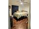 Bright bedroom with a queen-size bed and dark hardwood floors at 3180 Sixma Rd, Lake Helen, FL 32744