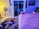 Bedroom with pool view, plush bedding, and unique decor at 3180 Sixma Rd, Lake Helen, FL 32744