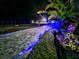 Brick driveway with blue lights at night at 3180 Sixma Rd, Lake Helen, FL 32744