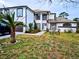 Two-story house with white exterior, brown accents, and a landscaped yard at 3180 Sixma Rd, Lake Helen, FL 32744