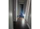 Light-filled hallway with dark hardwood floors at 3180 Sixma Rd, Lake Helen, FL 32744