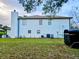 White two-story house with a brown roof and AC units at 3180 Sixma Rd, Lake Helen, FL 32744