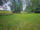 Vacant lot with grassy area and trees at 3180 Sixma Rd, Lake Helen, FL 32744