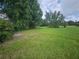 Overgrown grassy lot with trees at 3180 Sixma Rd, Lake Helen, FL 32744