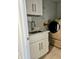Laundry room with white cabinets and modern washer/dryer at 3180 Sixma Rd, Lake Helen, FL 32744