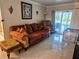 Living room with ornate sofa and view of the pool at 3180 Sixma Rd, Lake Helen, FL 32744