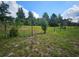 Partially fenced lot with trees and grassy areas at 3180 Sixma Rd, Lake Helen, FL 32744