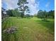 Spacious pasture with mature trees and wooden fence at 3180 Sixma Rd, Lake Helen, FL 32744