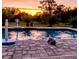 Relaxing pool scene with a dog and sunset view at 3180 Sixma Rd, Lake Helen, FL 32744