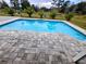 Sparkling blue pool with gray pavers at 3180 Sixma Rd, Lake Helen, FL 32744