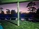 Inviting pool area with landscape lighting at night at 3180 Sixma Rd, Lake Helen, FL 32744