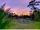Scenic sunset view over a grassy field with a fence at 3180 Sixma Rd, Lake Helen, FL 32744