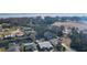 Overhead perspective of homes along canals leading to a lake, surrounded by lush greenery and a plowed field at 35534 Quail Run, Leesburg, FL 34788
