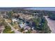 Stunning aerial view of a waterfront community, featuring a lake, canals, and well-maintained homes at 35534 Quail Run, Leesburg, FL 34788