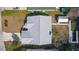 Aerial view of a residential home with a large paved driveway and surrounded by a green lawn at 35534 Quail Run, Leesburg, FL 34788