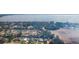 Expansive view showing a neighborhood by a clear lake, adjacent to a large open field, creating a serene setting at 35534 Quail Run, Leesburg, FL 34788