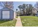Grassy backyard with shed and views of the water at 35534 Quail Run, Leesburg, FL 34788