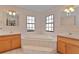 Bathroom with a luxurious soaking tub, tile flooring, and natural light at 35534 Quail Run, Leesburg, FL 34788