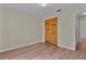 Bright bedroom with wood-look floors and closet with shutter doors at 35534 Quail Run, Leesburg, FL 34788