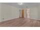 Bedroom features wood-look flooring, neutral paint, and access to the bathroom at 35534 Quail Run, Leesburg, FL 34788