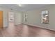 Comfortable bedroom featuring wood-look flooring and an attached bathroom at 35534 Quail Run, Leesburg, FL 34788