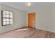 Bedroom featuring wood-look floors, large window and built in wardrobe at 35534 Quail Run, Leesburg, FL 34788