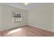 Bedroom with wood-look flooring, and a large window for ample natural light at 35534 Quail Run, Leesburg, FL 34788