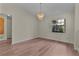 Cozy dining area with hardwood floors, a modern chandelier, and a view of the outside at 35534 Quail Run, Leesburg, FL 34788