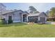Charming single Gathering home features a two-car garage, well-manicured lawn, and fresh exterior paint at 35534 Quail Run, Leesburg, FL 34788