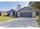 Charming single Gathering home features a two-car garage, well-manicured lawn, and fresh exterior paint at 35534 Quail Run, Leesburg, FL 34788