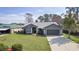 Beautiful single-Gathering home featuring a 2-car garage and a lush, green lawn at 35534 Quail Run, Leesburg, FL 34788
