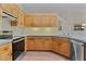 Well-lit kitchen features light wood cabinetry, stainless steel appliances, and tile backsplash at 35534 Quail Run, Leesburg, FL 34788