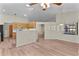 Open-concept kitchen and living area with wood cabinets at 35534 Quail Run, Leesburg, FL 34788