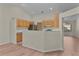 Bright kitchen featuring wood cabinets, breakfast bar, and sleek stainless steel appliances at 35534 Quail Run, Leesburg, FL 34788