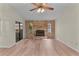 Spacious living room with brick fireplace and sliding door to back yard at 35534 Quail Run, Leesburg, FL 34788