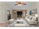 Cozy living room with brick fireplace, modern decor, and sliding glass doors at 35534 Quail Run, Leesburg, FL 34788