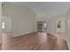 A neutrally decorated living room with wood floors and sliding doors to the lanai at 35534 Quail Run, Leesburg, FL 34788