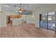 Open-concept living area flowing into kitchen with sliding doors to back yard at 35534 Quail Run, Leesburg, FL 34788