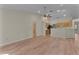 Open-concept living area featuring wood-look floors that flow into the kitchen at 35534 Quail Run, Leesburg, FL 34788