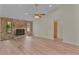 Spacious living room with brick fireplace and ceiling fan at 35534 Quail Run, Leesburg, FL 34788