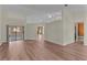 Expansive living area with hardwood floors, a sliding glass door, and neutral wall color at 35534 Quail Run, Leesburg, FL 34788