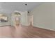 Spacious living room with wood floors, a front door with sidelights, and a stylish chandelier at 35534 Quail Run, Leesburg, FL 34788