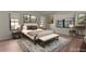 Bright bedroom featuring neutral decor, a comfortable queen bed, and large windows for natural light at 35534 Quail Run, Leesburg, FL 34788